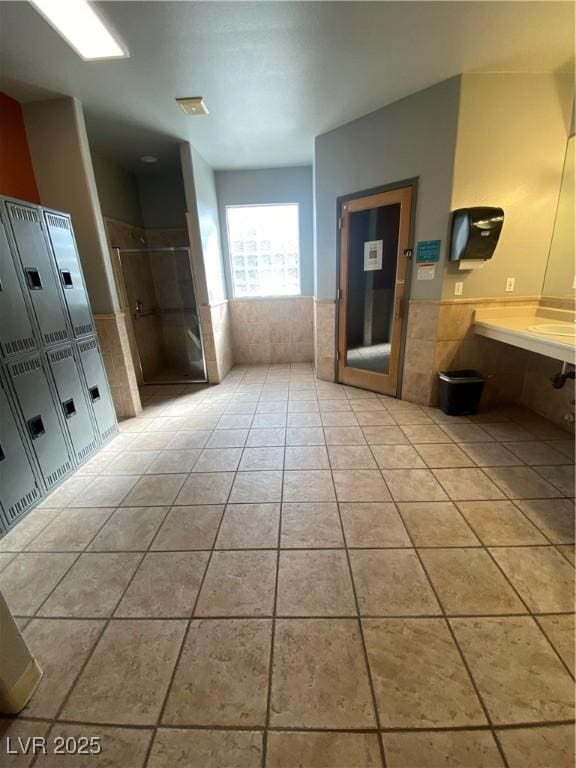 full bathroom featuring a stall shower and tile patterned flooring