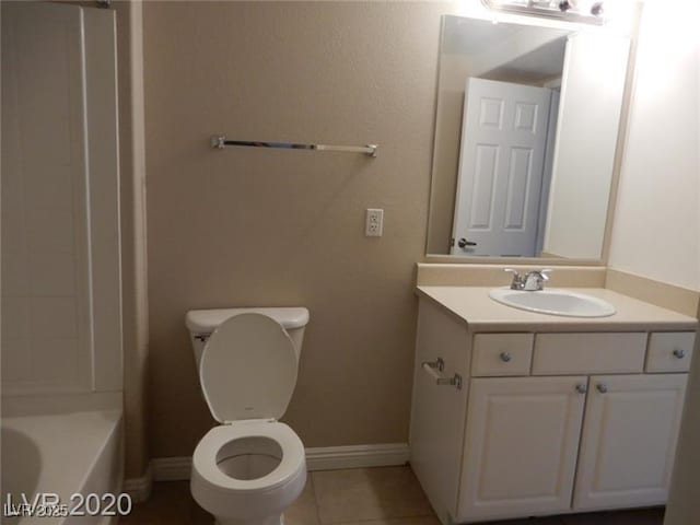 full bathroom with vanity, tile patterned floors, toilet, and baseboards