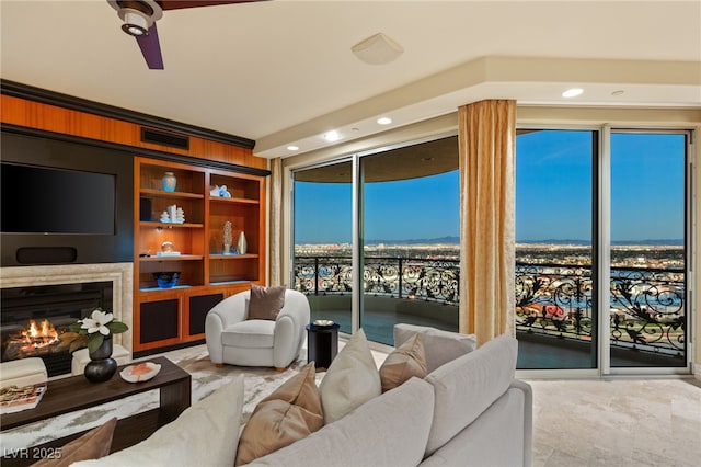 living room with a glass covered fireplace and visible vents