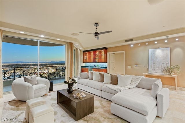 living area with recessed lighting, visible vents, and ceiling fan