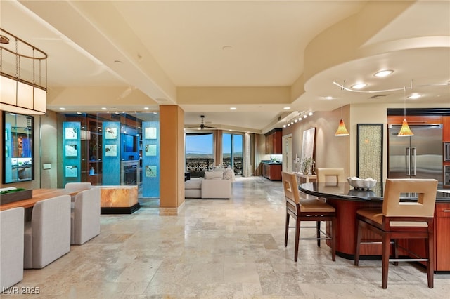 dining space featuring recessed lighting, stone finish floor, and a fireplace