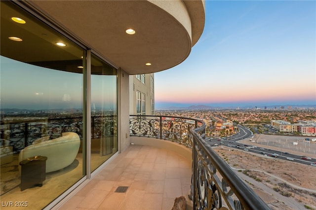 balcony at dusk with a view of city