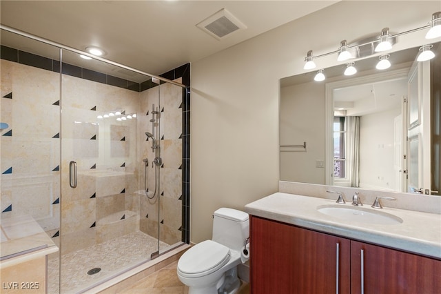 full bathroom with vanity, visible vents, a stall shower, tile patterned floors, and toilet