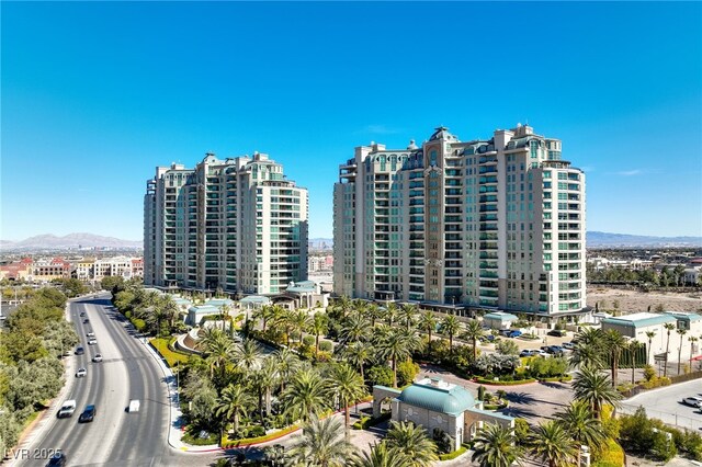 view of building exterior with a mountain view and a view of city