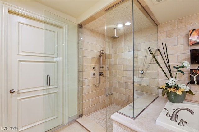 full bathroom featuring a bath, tiled shower, and a sink