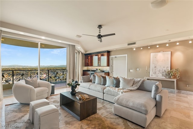 living area featuring track lighting, a ceiling fan, and visible vents