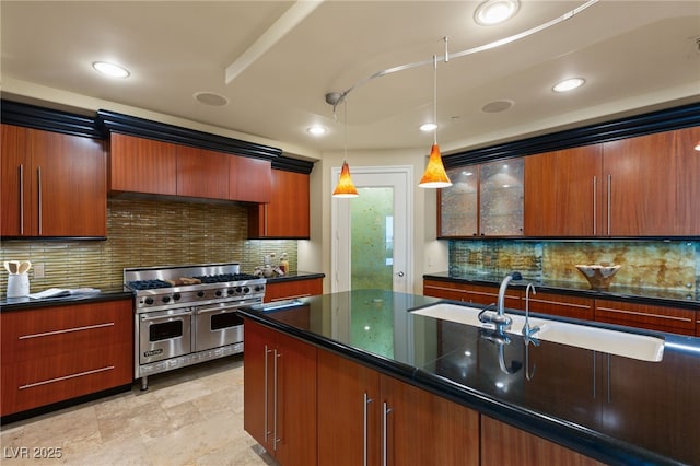 kitchen with decorative light fixtures, dark countertops, recessed lighting, range with two ovens, and decorative backsplash