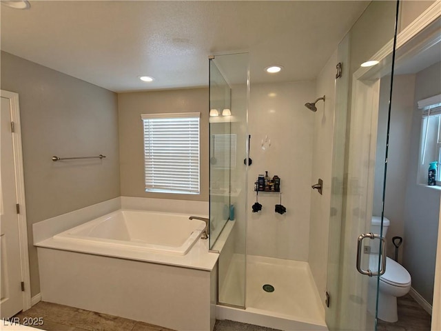 full bathroom featuring recessed lighting, a shower stall, toilet, and a garden tub