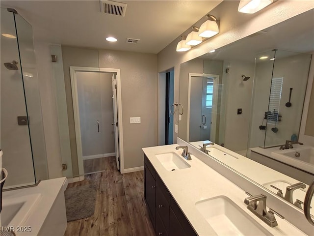 bathroom with a sink, visible vents, a garden tub, and a shower stall