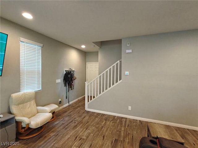 sitting room featuring stairs, recessed lighting, wood finished floors, and baseboards