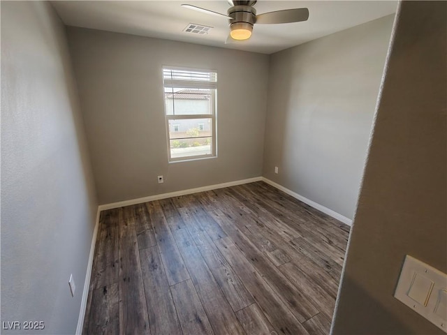 unfurnished room featuring visible vents, baseboards, ceiling fan, and dark wood-style flooring