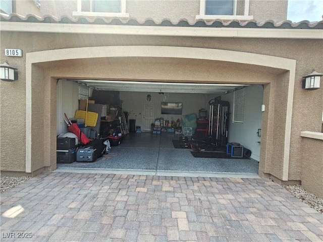 garage featuring decorative driveway