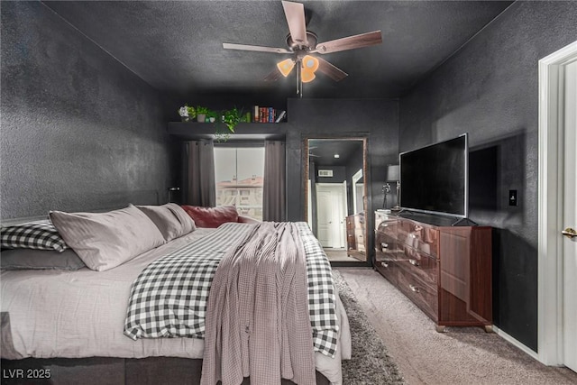 carpeted bedroom featuring a textured ceiling, a ceiling fan, and a textured wall