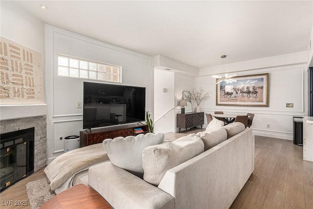 living room with wood finished floors and a fireplace