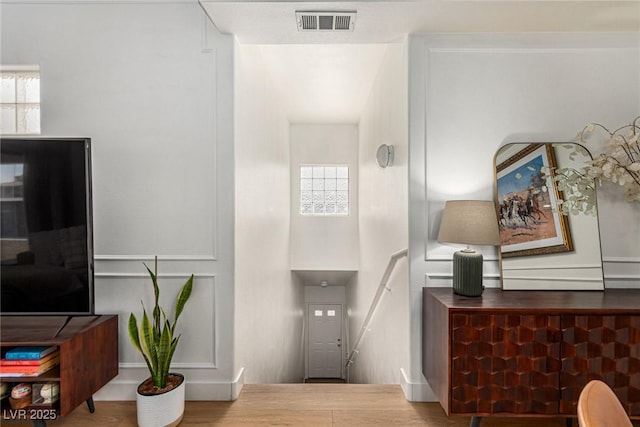 interior space featuring wood finished floors and visible vents