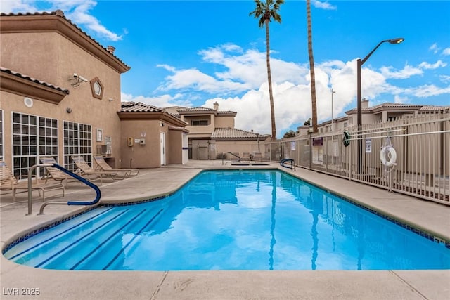 pool featuring a patio area and fence