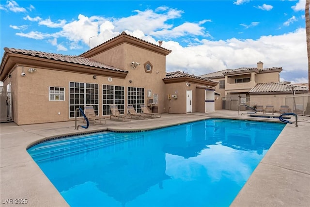 view of swimming pool with a fenced in pool, a patio, and fence