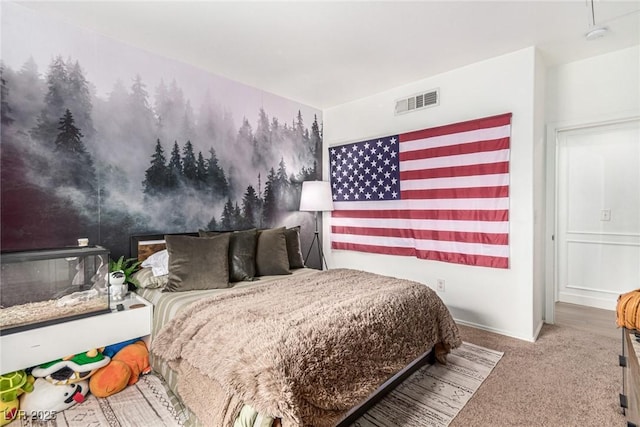 bedroom with visible vents and carpet flooring