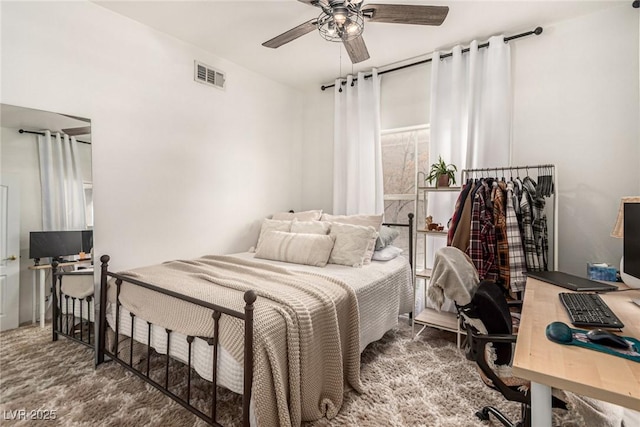 carpeted bedroom with visible vents and ceiling fan