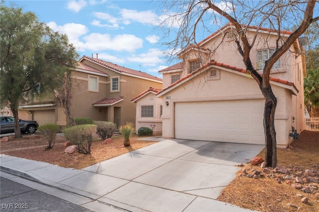 mediterranean / spanish-style home featuring stucco siding, concrete driveway, and a tile roof