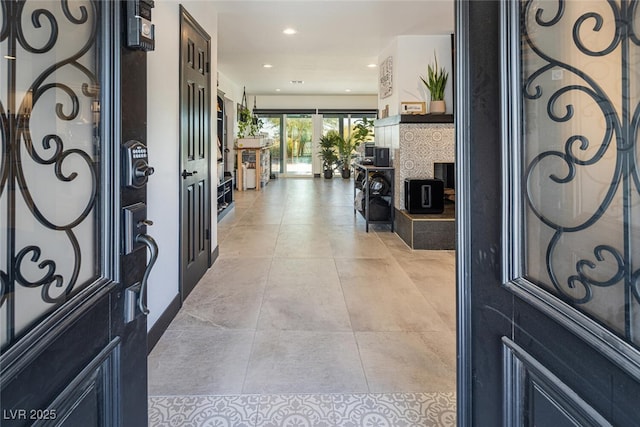 entryway with light tile patterned flooring and recessed lighting