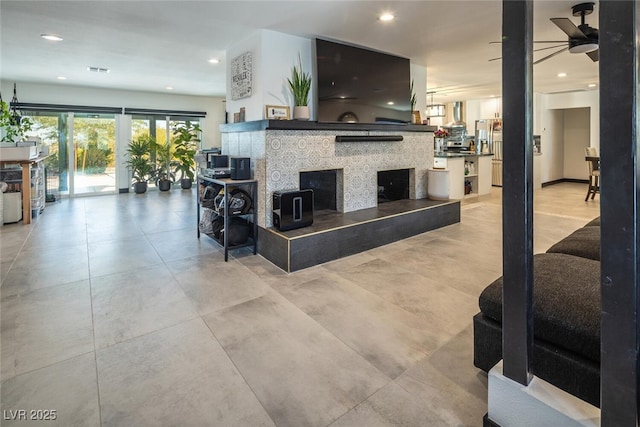 interior space featuring visible vents, recessed lighting, a fireplace, and ceiling fan