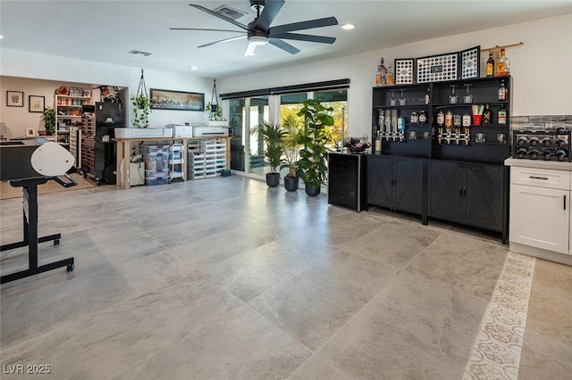 interior space with a bar, recessed lighting, visible vents, and ceiling fan