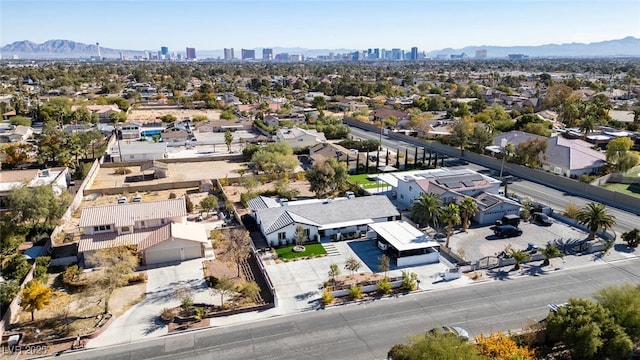 birds eye view of property with a city view and a mountain view