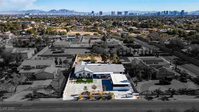 drone / aerial view featuring a mountain view and a view of city