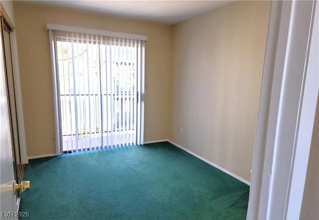 carpeted spare room with baseboards