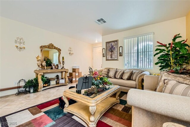 living room featuring light tile patterned floors and visible vents