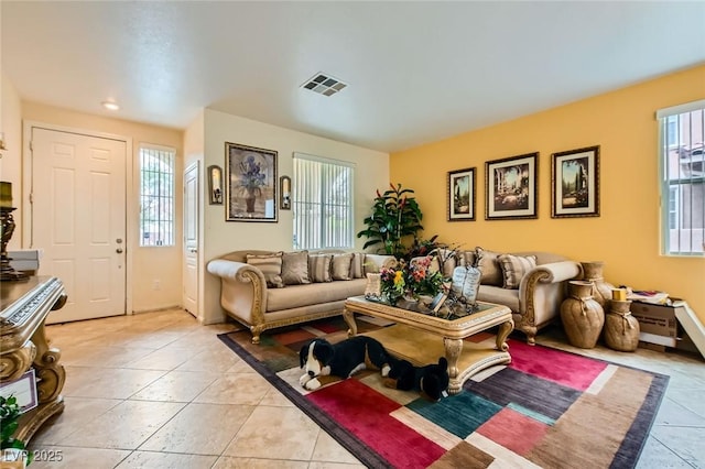 living room with light tile patterned floors and visible vents