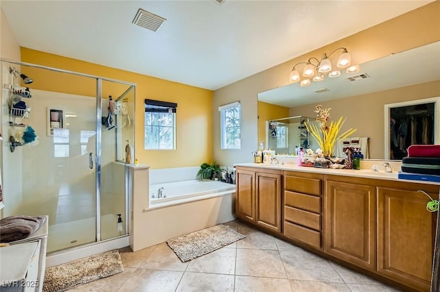 full bath featuring visible vents, double vanity, a stall shower, tile patterned flooring, and a garden tub