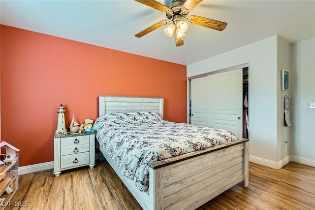 bedroom featuring a closet, baseboards, and wood finished floors