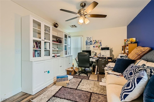 office with visible vents, wood finished floors, and ceiling fan