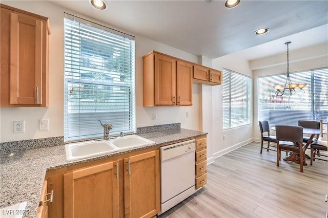 kitchen featuring light wood finished floors, recessed lighting, a sink, hanging light fixtures, and dishwasher