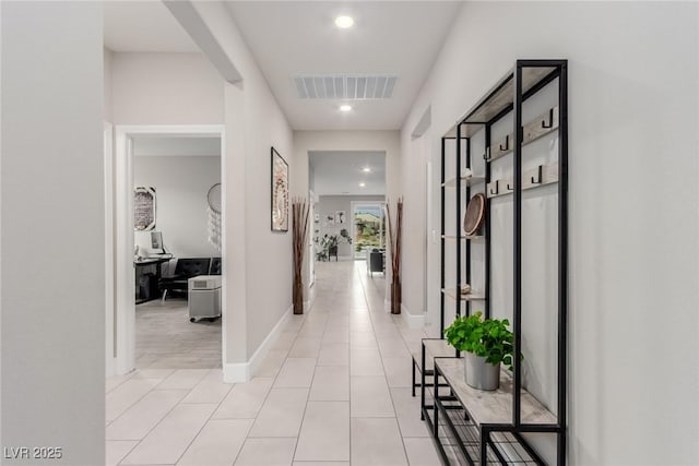 hall with recessed lighting, visible vents, baseboards, and light tile patterned flooring