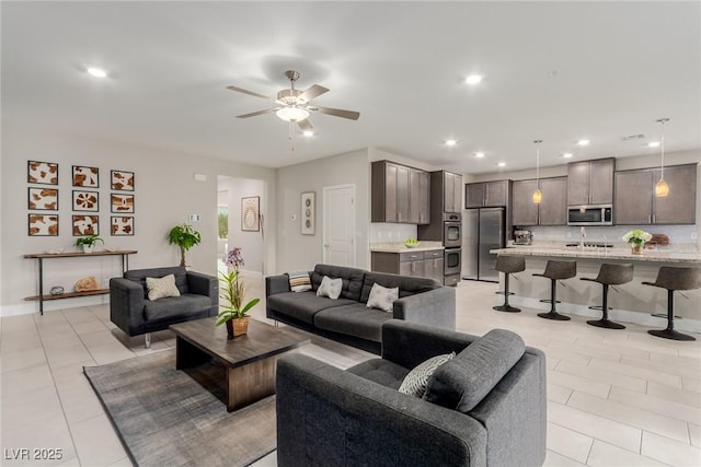 living area featuring light tile patterned floors, recessed lighting, and a ceiling fan