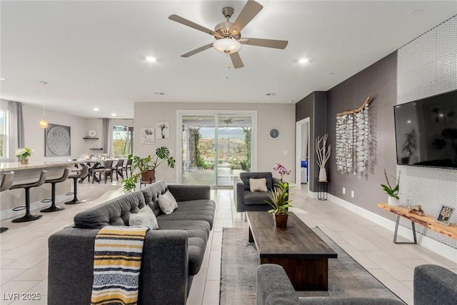 living room featuring light tile patterned floors, recessed lighting, baseboards, and ceiling fan