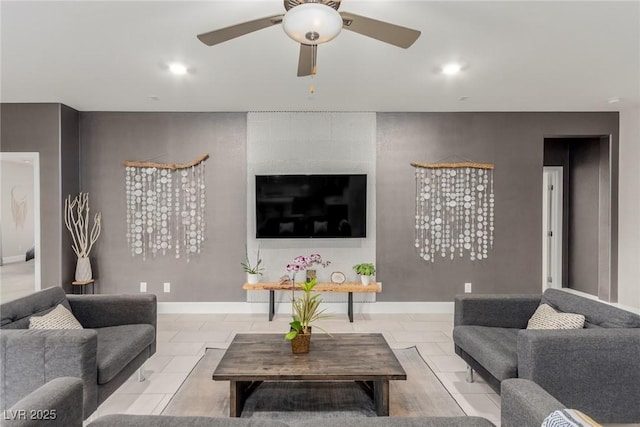 living area with recessed lighting, a ceiling fan, and baseboards