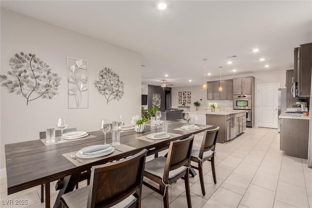 dining space featuring light tile patterned floors and recessed lighting