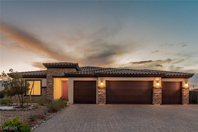 view of front of home with a garage, driveway, and stucco siding