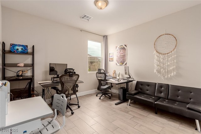 home office featuring visible vents, baseboards, and wood finished floors