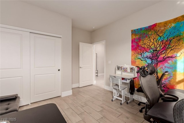 office area with baseboards and wood finish floors