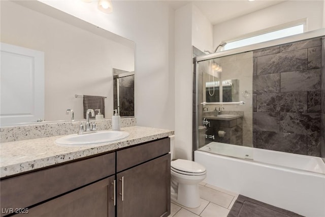 bathroom with vanity, toilet, shower / bath combination with glass door, and tile patterned flooring