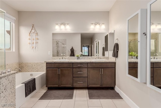 full bathroom with a sink, plenty of natural light, a shower stall, double vanity, and a bath