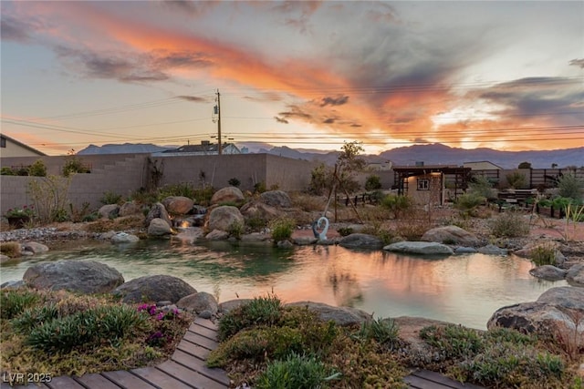 exterior space featuring a mountain view and fence