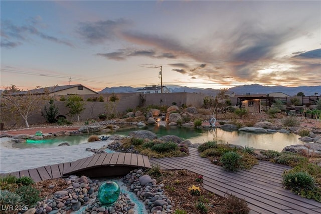 exterior space with a mountain view and fence