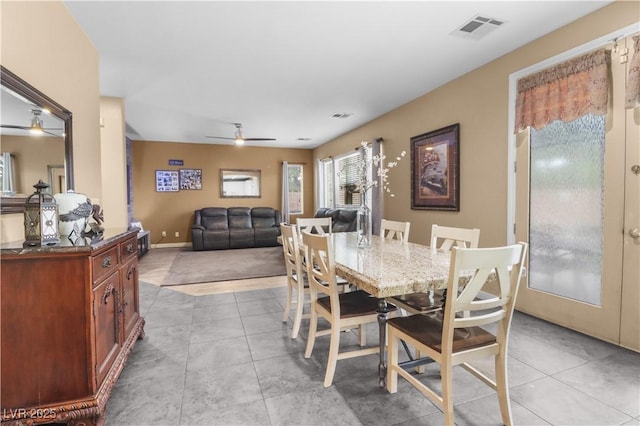 dining space with tile patterned flooring, a ceiling fan, and visible vents