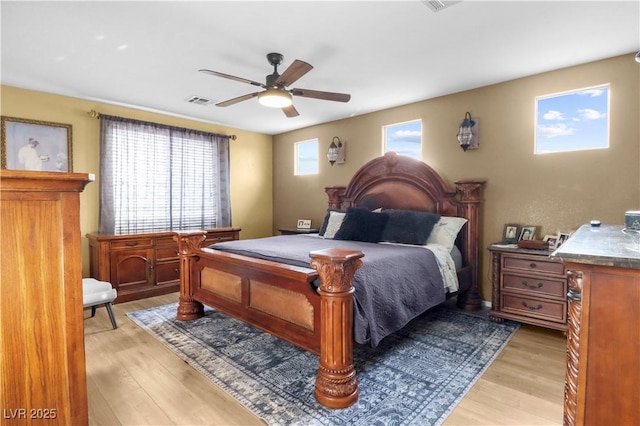 bedroom with visible vents, light wood-style flooring, and ceiling fan